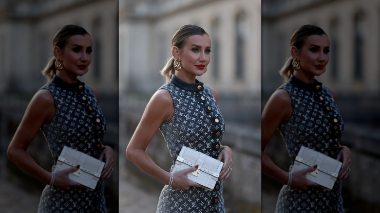 woman wearing dress with metal buttons