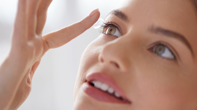 Woman applying contacts
