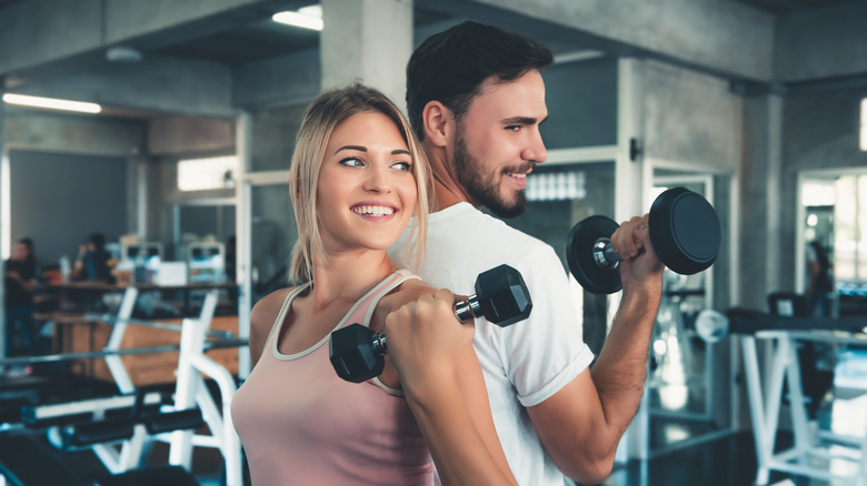 Man and woman lifting weights 