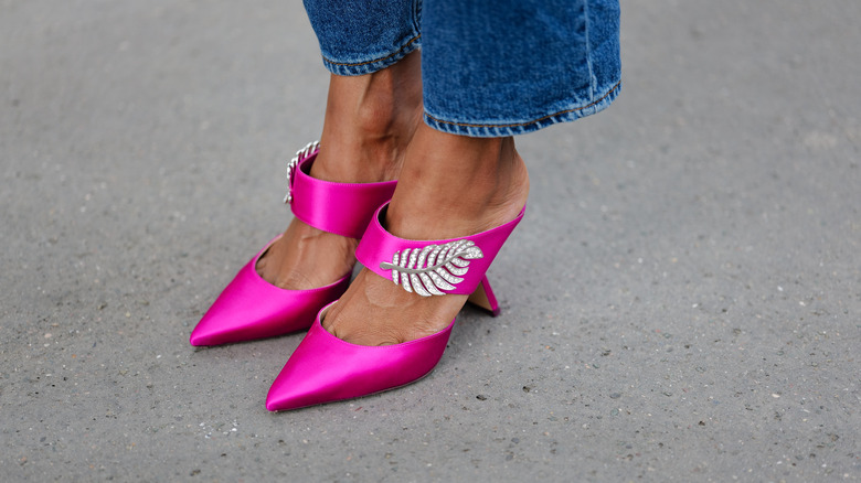 Woman wearing pink shoes, feather accessory