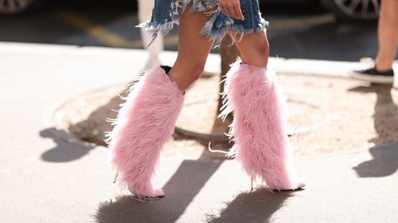 woman wearing feathered boots