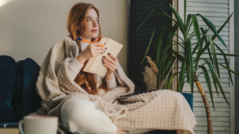 Woman writing in journal