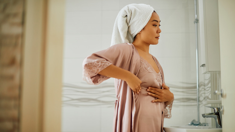 woman doing breast self-examination 