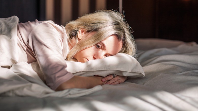 Woman upset in bed