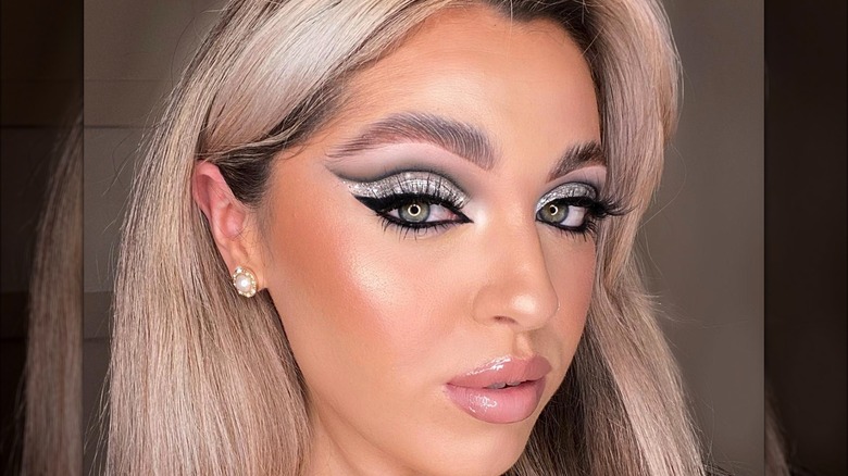 A woman with silver cut crease makeup