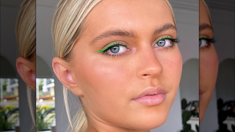 A woman with green eyeliner