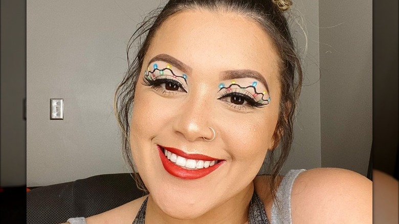 A woman with Christmas light makeup