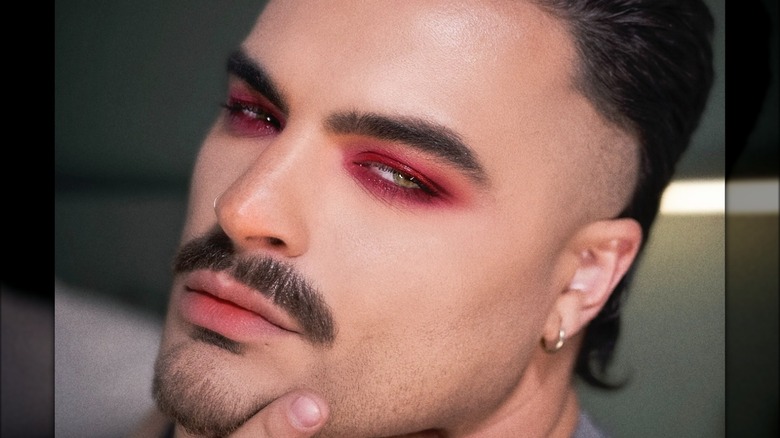 A man with red eye makeup