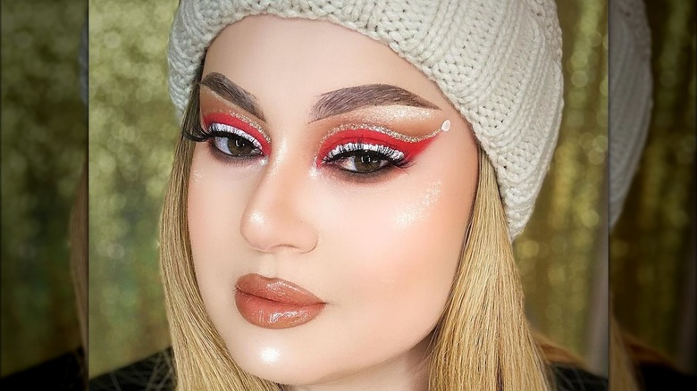 A woman with red santa makeup