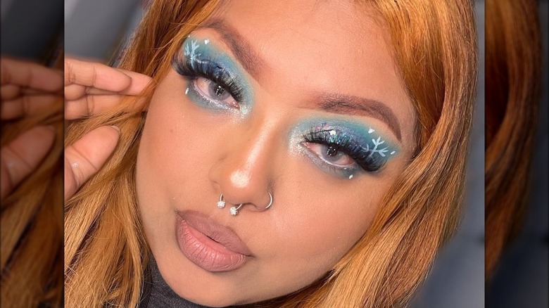 A woman with icy blue makeup