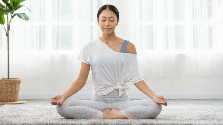Woman meditates with closed eyes
