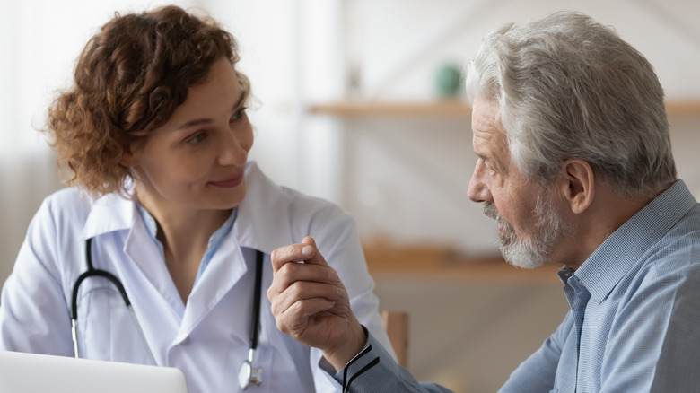 Doctor consulting with older patient