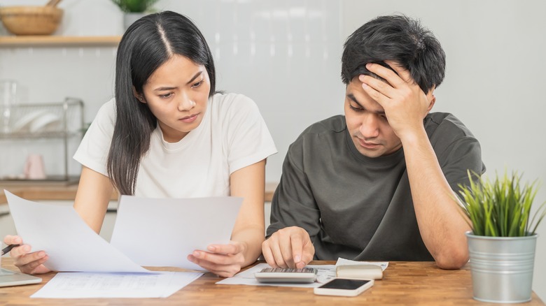 Couple calculating at table