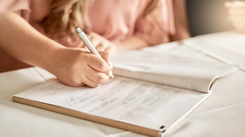 Person writing in notebook