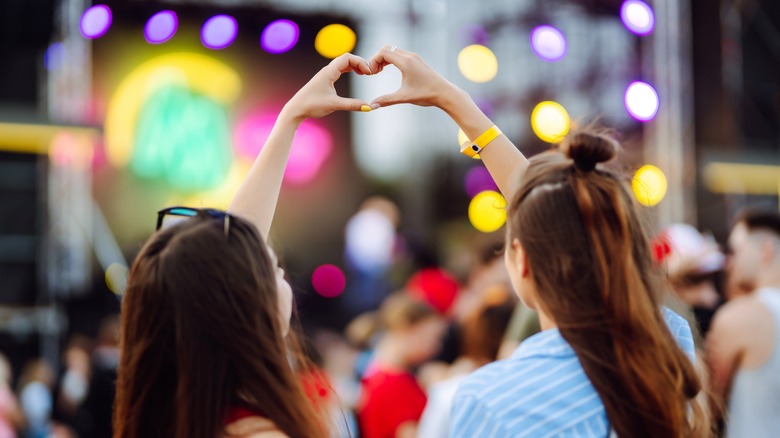 two women forming heart shape