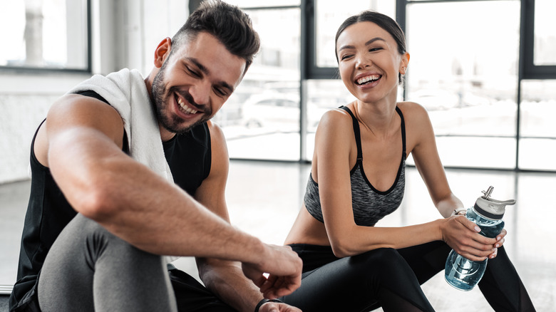 man and woman laughing after exercise