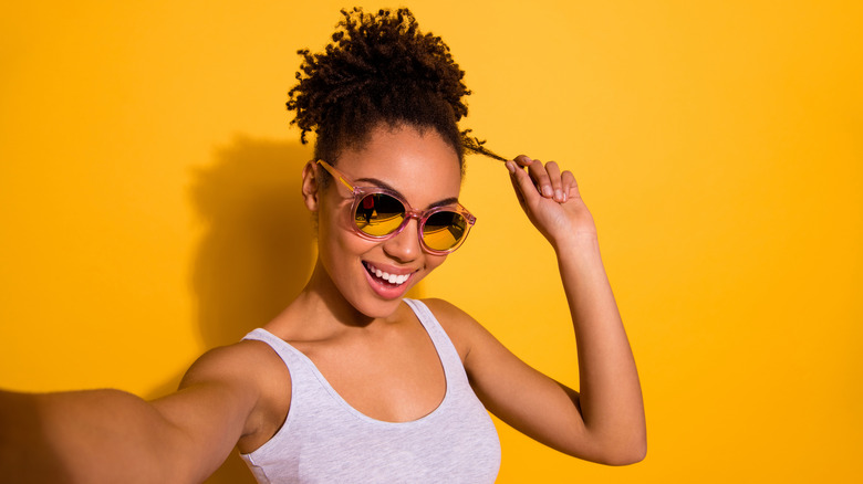 woman with curly hair smiling at camera