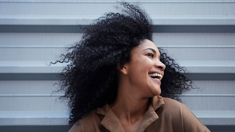 Woman with curly hair smiling