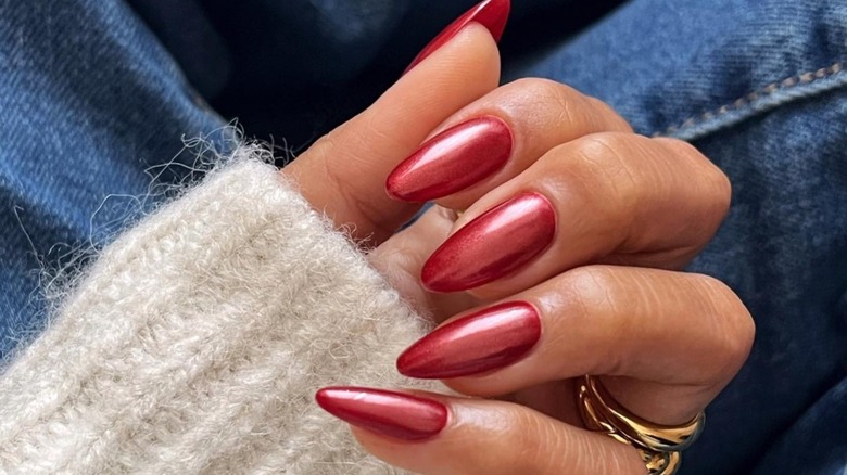 Hand displaying red chrome nails