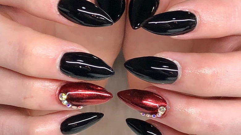 Hands with red, black chrome nails