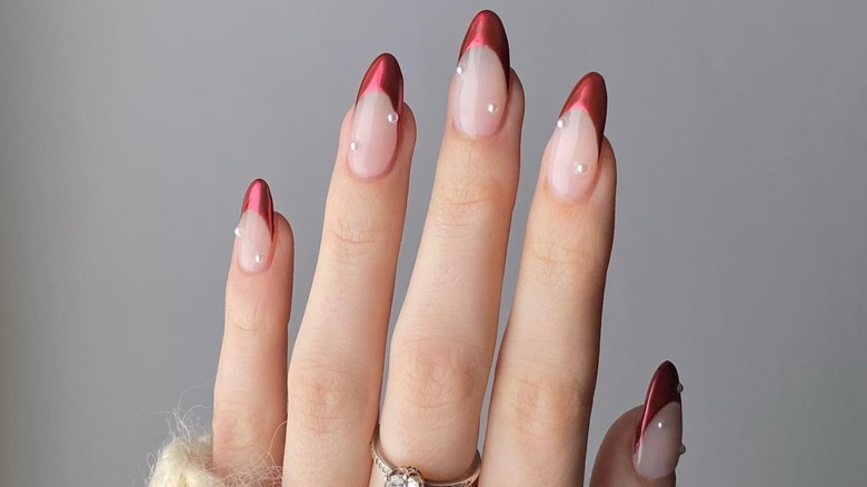 Hand with red chrome French manicure