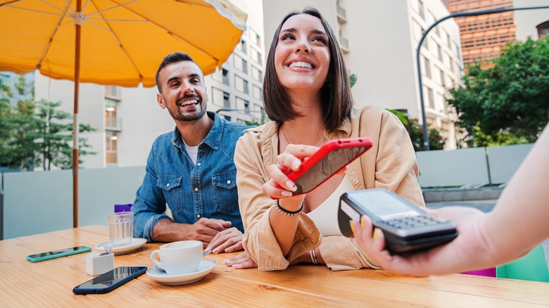 Woman paying bill at restaurant