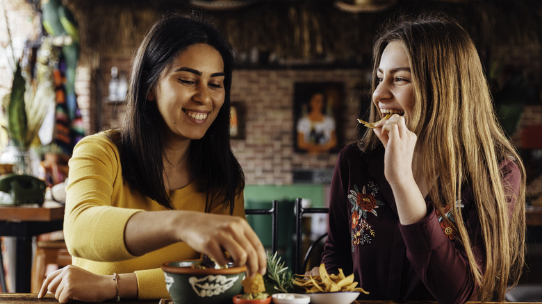 Couple eating corn chips