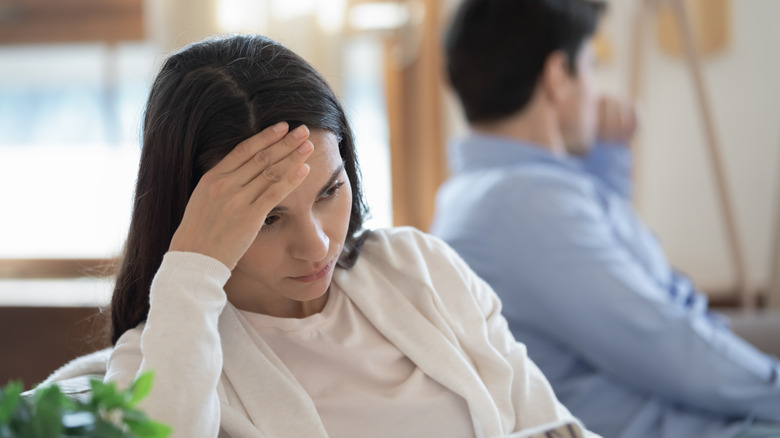 Woman with hand on forehead, stubborn