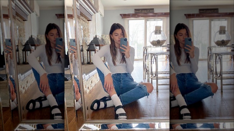 woman sitting on floor with black flatforms and white socks