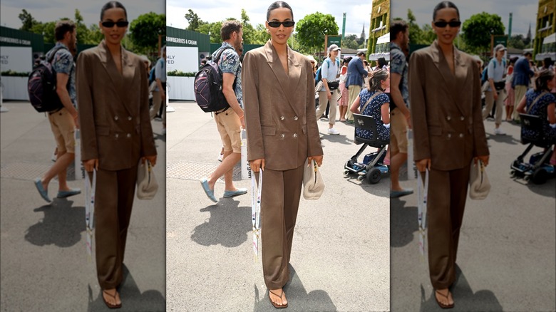 Person in a brown suit and flip-flops