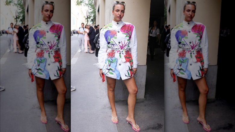 Person in a floral jacket dress and pink flip-flops