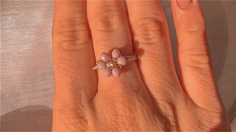 Instagram user @ringringhellojewelry showing flower-shaped pink ring