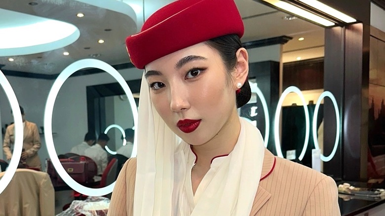 Emirates flight attendant in front of mirror