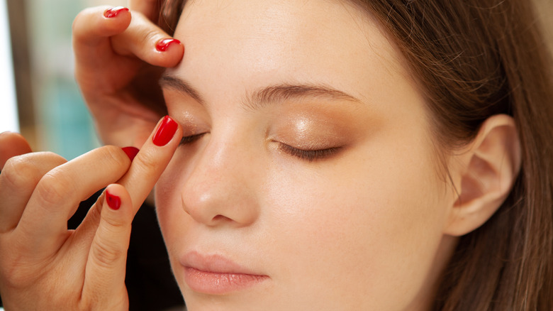 applying primer to eyelids