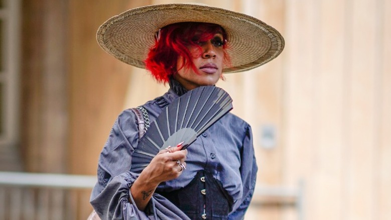 woman with a blue folding fan