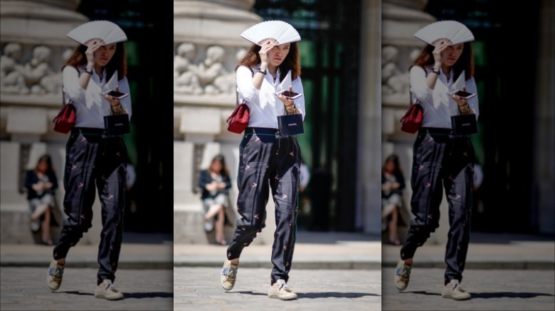 woman with a white folding fan