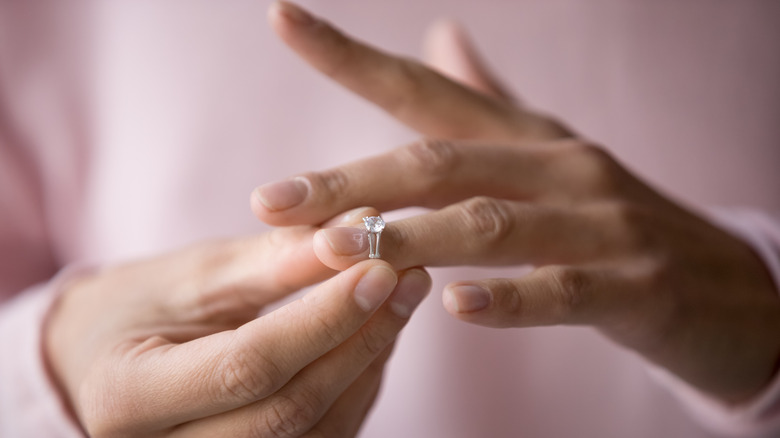 A woman removing her ring