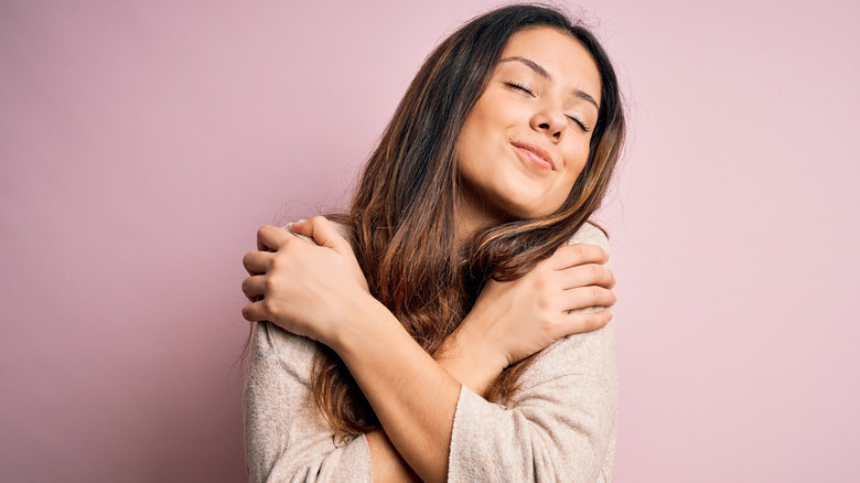 A woman hugging herself