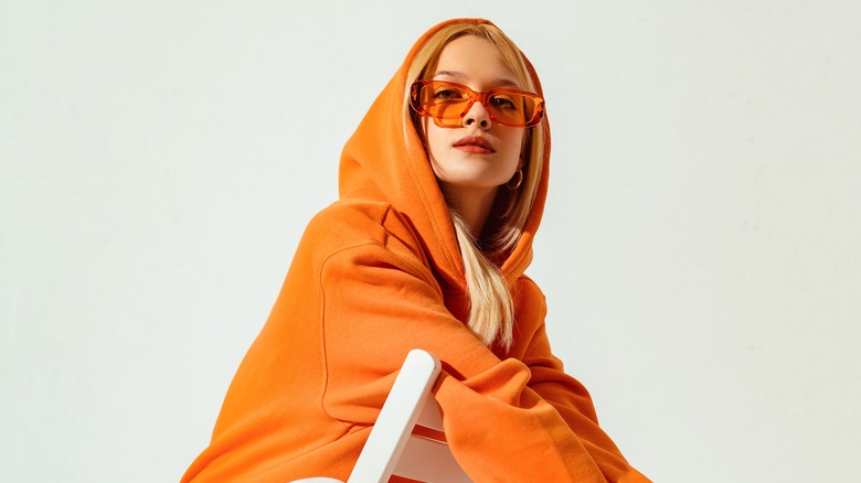 A strong woman wearing orange