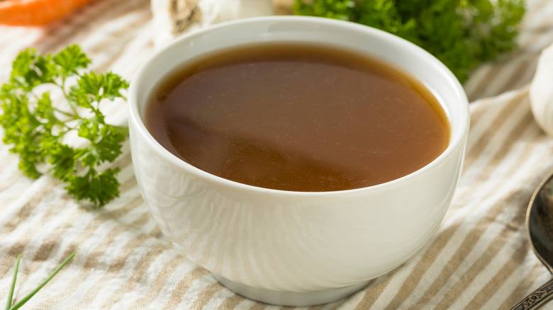 Beef bone broth in white bowl