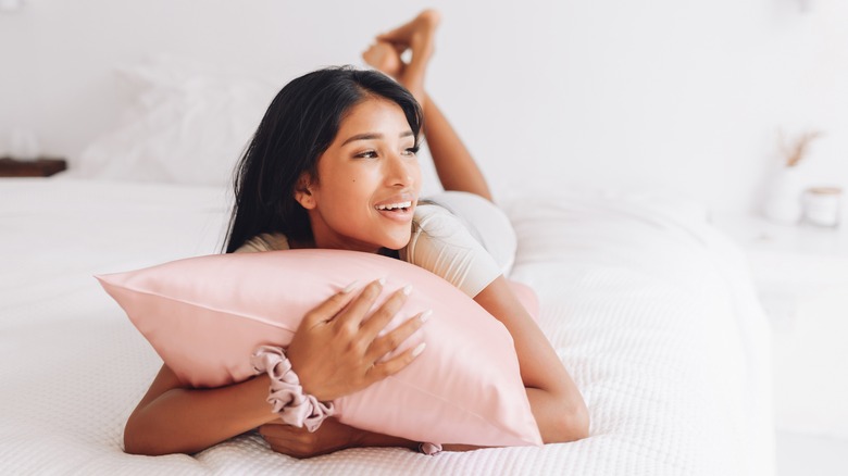 Girl holding silk pillowcase 