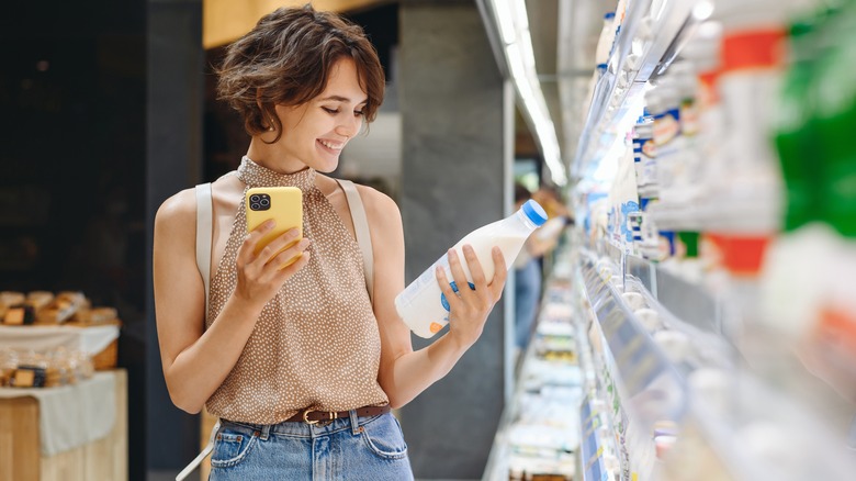 A woman buying milk