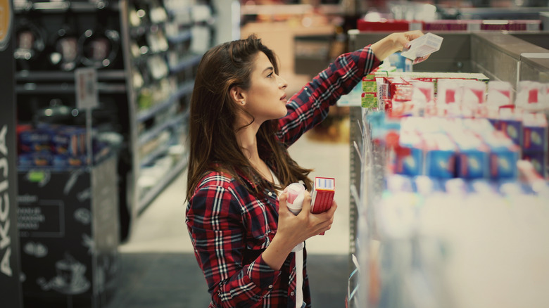 A woman buying toothpaste