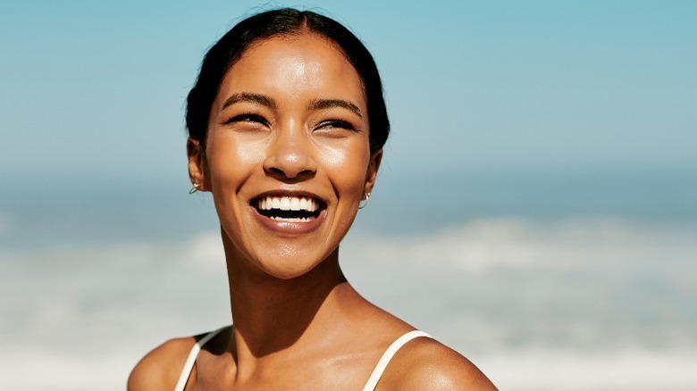 Woman with glowing skin at the beach