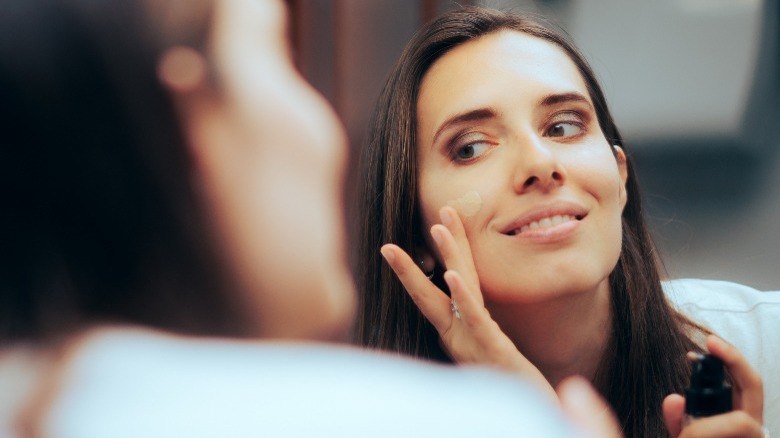 Woman applying a liquid foundation