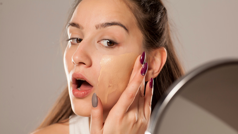 woman Applying foundation with fingers