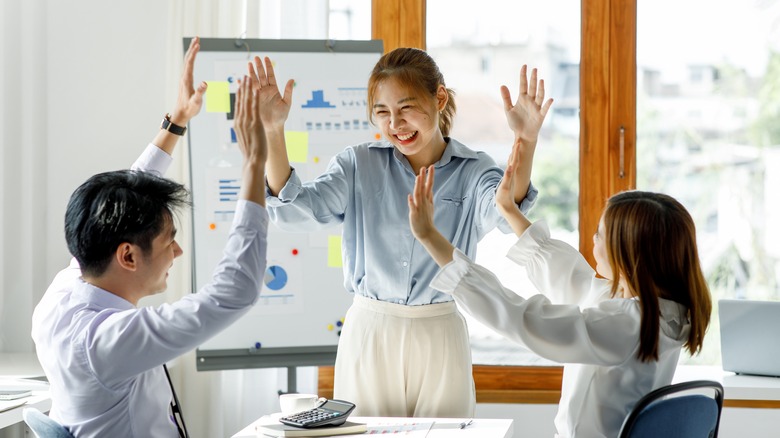 Work team high-fiving