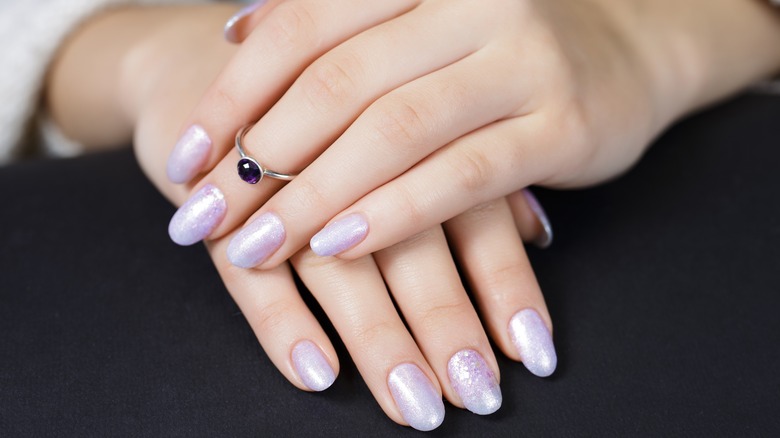 Hand with purple pearlescent manicure
