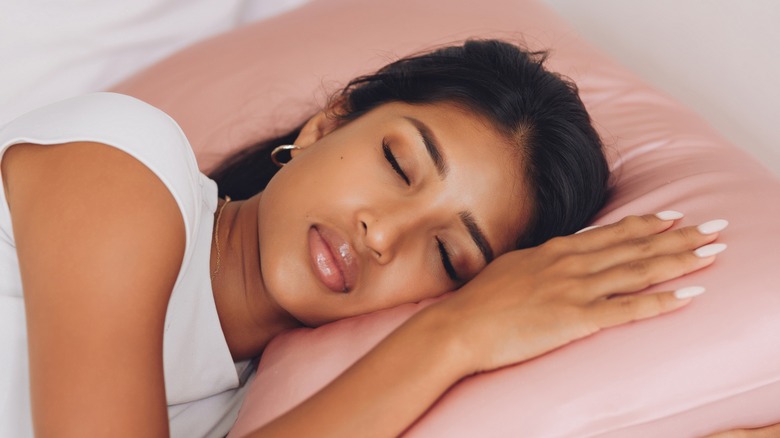 Woman sleeping on silk pillowcase