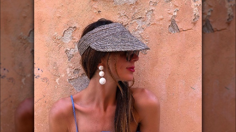 Girl wearing raffia sun visor